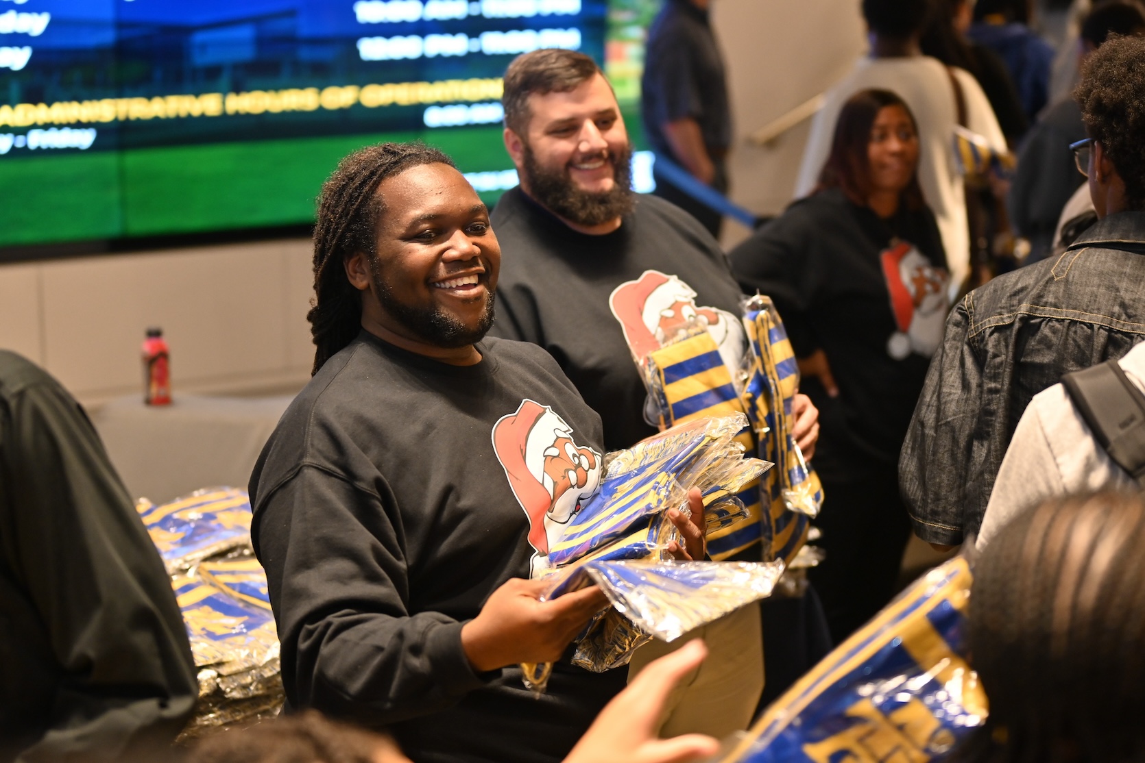 Assistant Director of Student Activities/Advisor to the Joint Greek Council Brandon Ratliff handing out gifts