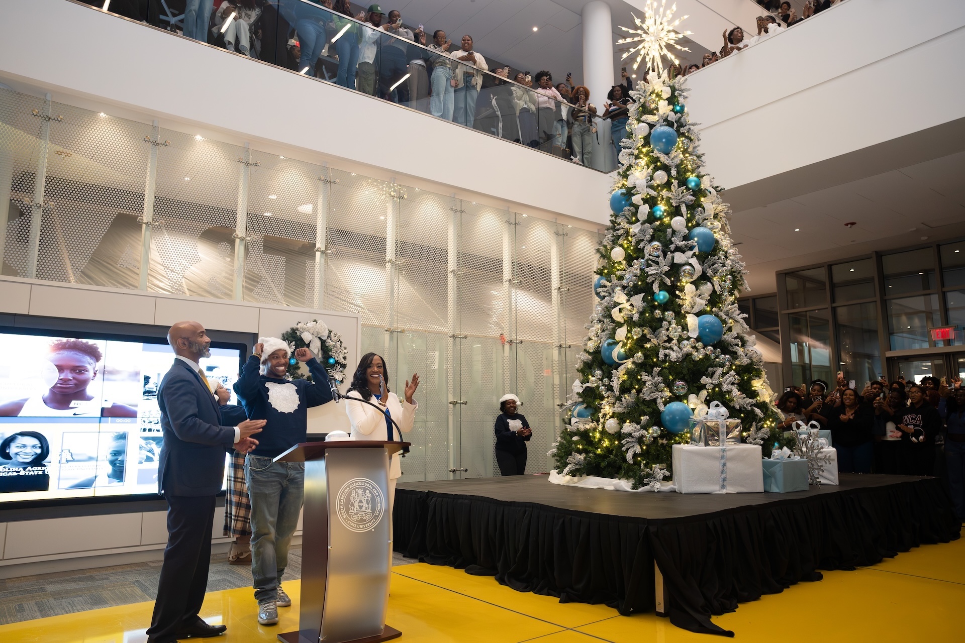 Student volunteer holding sign for 2025 Graduate Fair