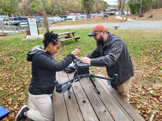 This is a photo of Eden and Michael with a drone