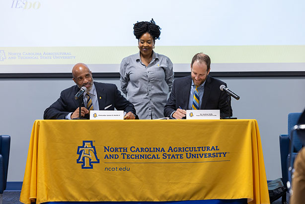 From left, Chancellor JAmes R. Martin II, Precious Bradley and Project Kitty Hawk President and CEO Andrew Kelly, Ph.D.