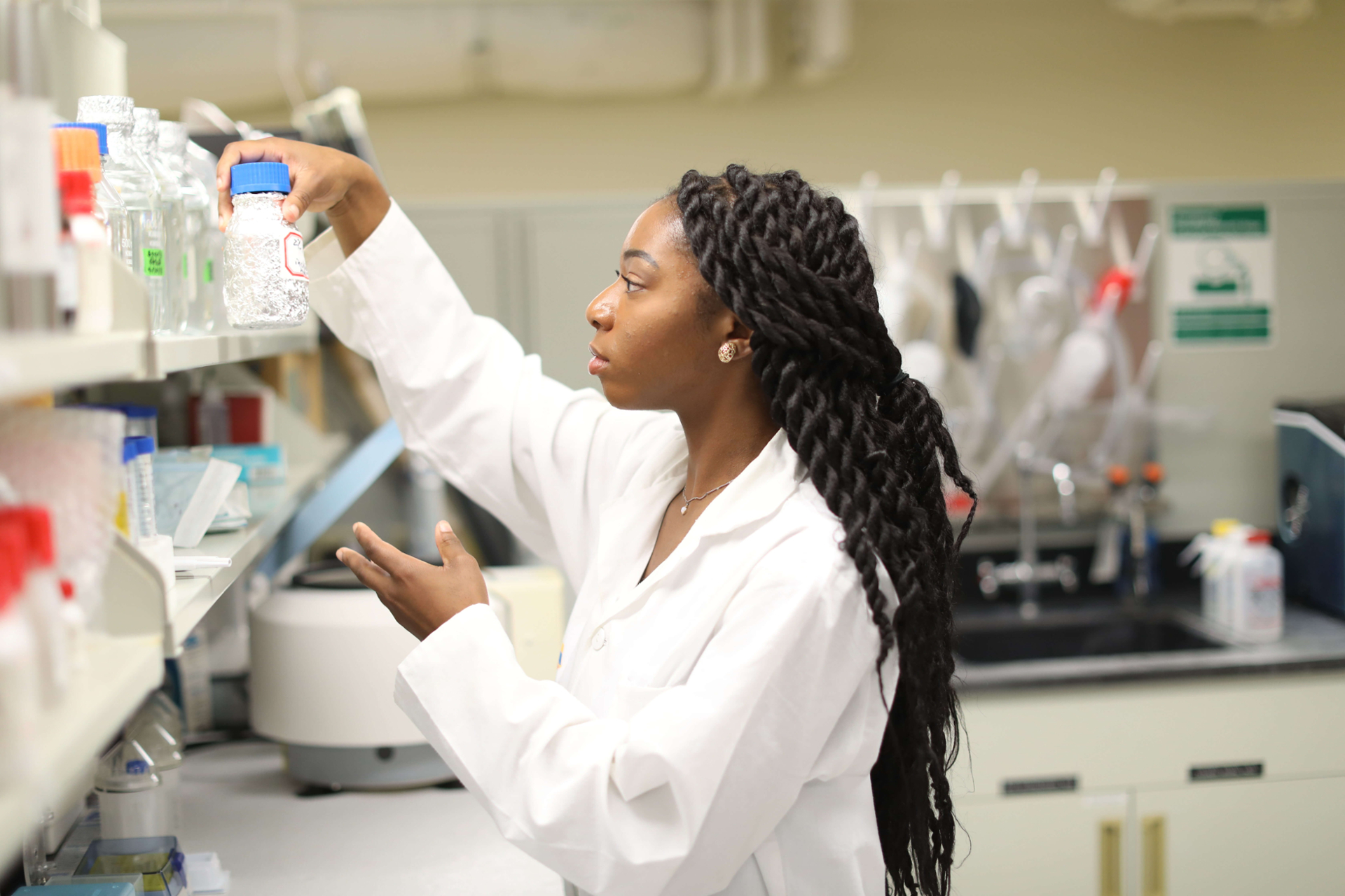 Female student with bottle in lab