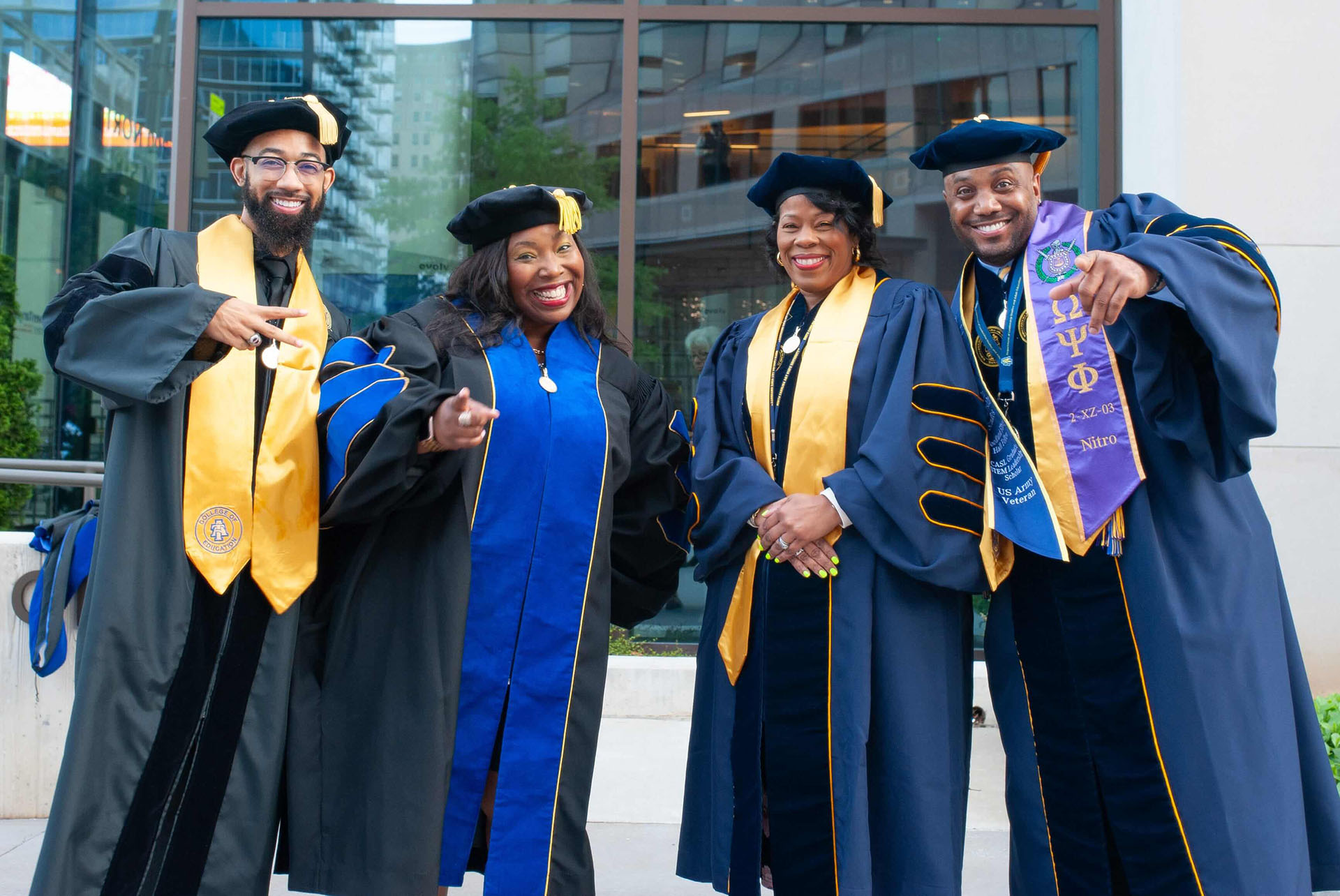 four graduate students at spring 2024 commencement